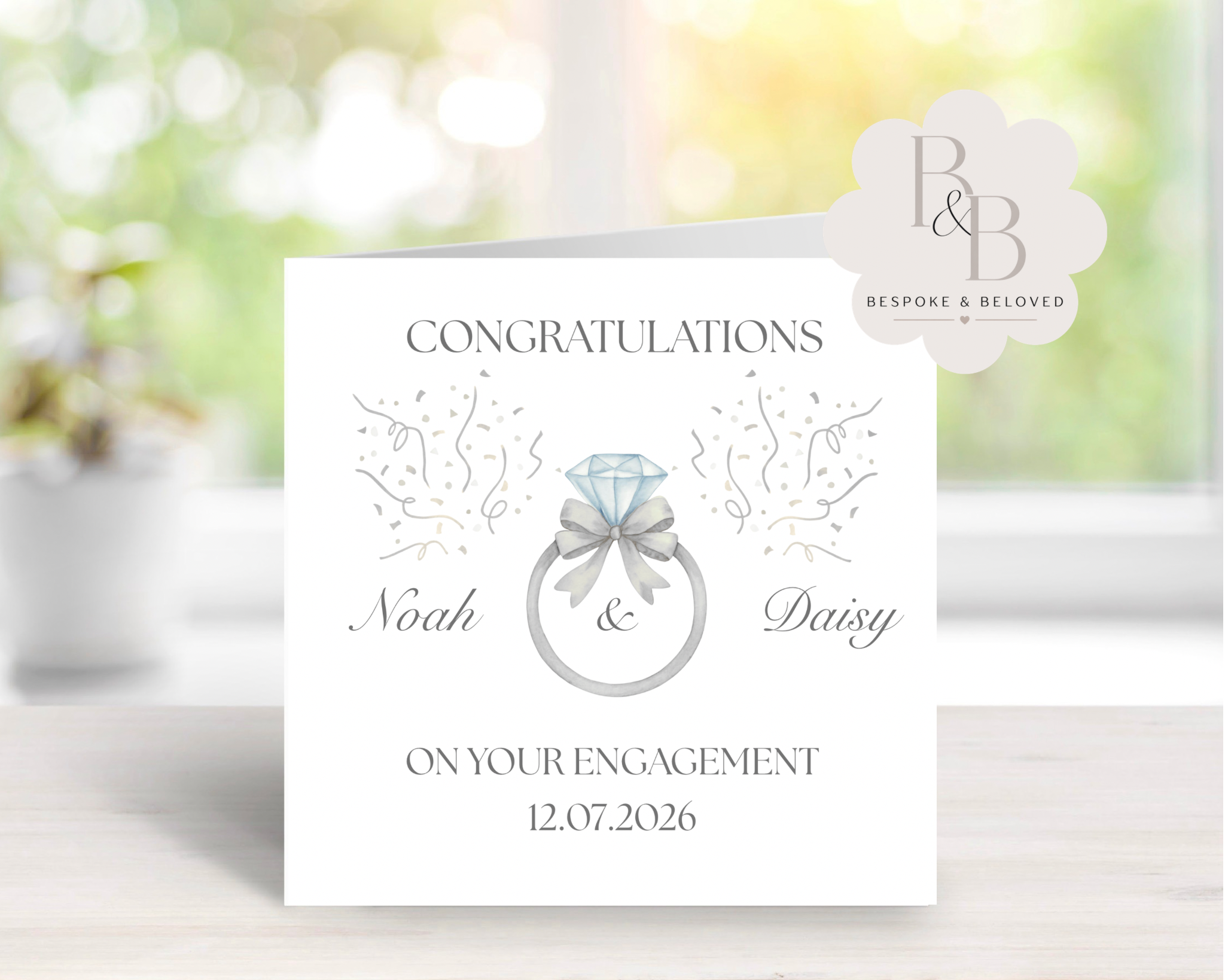 Engagement congratulations card with a diamond ring and bow design
