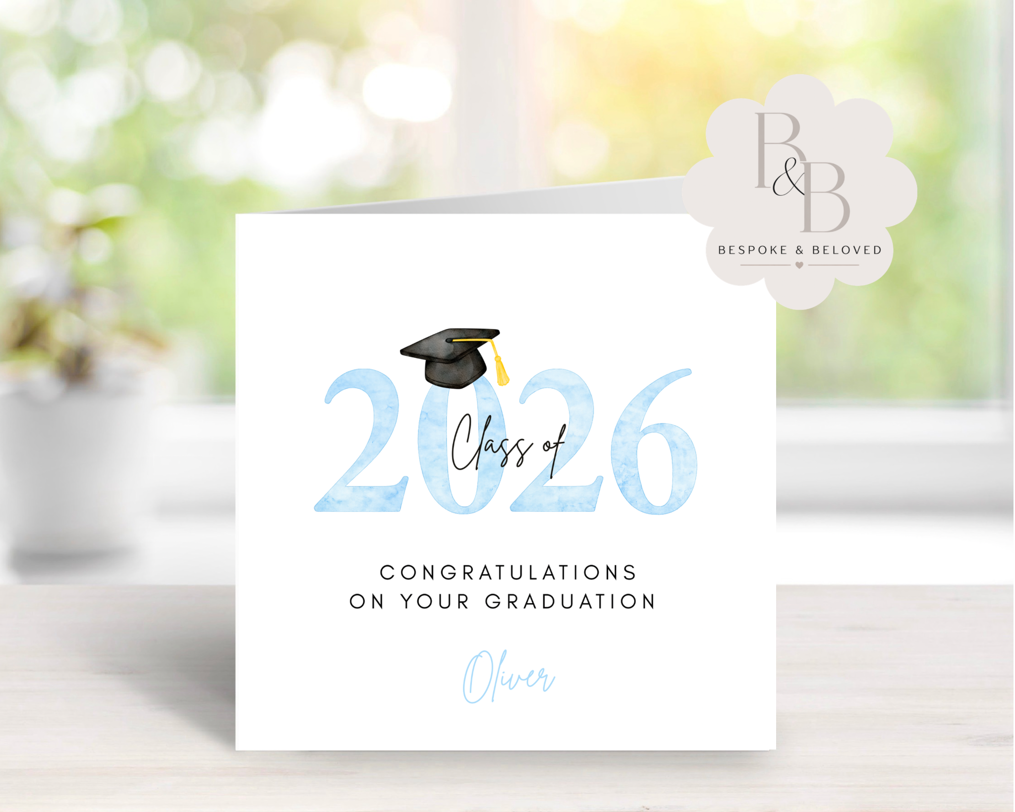 Blue graduation card with 'Class of 2026' text and a graduation cap 