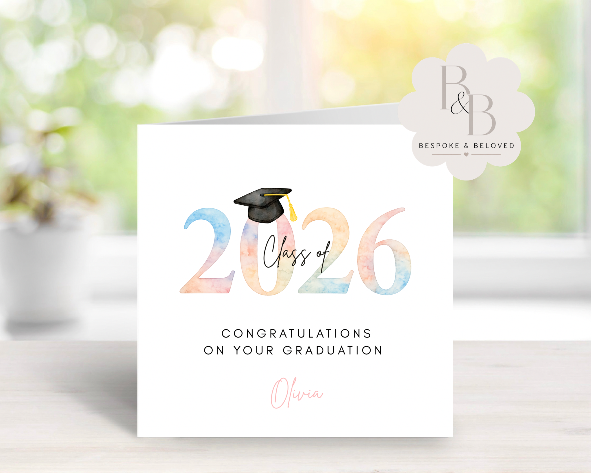 Rainbow graduation card with 'Class of 2026' text and a graduation cap design 